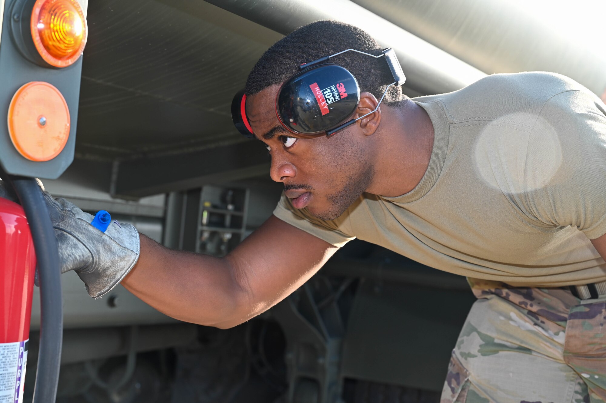 Man inspects fuel truck.