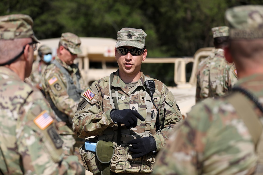 Sgt. 1st Class Steven Masters, Observer Coach/Trainer, 2-361st Training Support Battalion, 85th U.S. Army Reserve Support Command, based in Sioux Falls, South Dakota, briefs Command Sgt. Maj. Steven Slee, Command Sergeant Major, 85th USARSC, on the training lanes during CSTX 86-22-02 at Fort McCoy, Wisconsin, August 16, 2022.