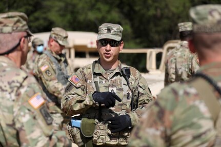 Sgt. 1st Class Steven Masters, Observer Coach/Trainer, 2-361st Training Support Battalion, 85th U.S. Army Reserve Support Command, based in Sioux Falls, South Dakota, briefs Command Sgt. Maj. Steven Slee, Command Sergeant Major, 85th USARSC, on the training lanes during CSTX 86-22-02 at Fort McCoy, Wisconsin, August 16, 2022.