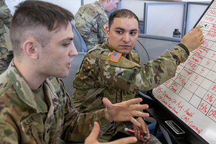 Spcs. Joshua Colon and Matthew Basala, 398th Financial Management Support Center financial management technicians, track exercise injection scenarios during Diamond Saber at Joint Base McGuire-Dix, New Jersey, Aug. 12, 2022. Established in 2004, Diamond Saber is a U.S. Army Reserve-led exercise that trains and evaluates Soldiers and joint partners on warfighting functions such as funding the force, payment support, disbursing operations, accounting, fiscal stewardship, auditability and data analytics. (U.S. Army photo by Mark R. W. Orders-Woempner)