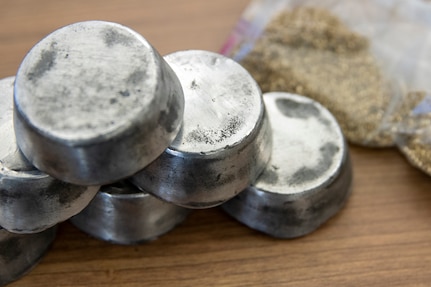 Fake silver and gold sits on a desk during Diamond Saber at Joint Base McGuire-Dix-Lakehurst, New Jersey, Aug. 13, 2022. Finance and comptroller Soldiers participating in Diamond Saber work through exercise scenarios where precious metals and gems are found on the battlefield and turned into their respective finance offices. (U.S. Army photo by Mark R. W. Orders-Woempner)