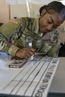 Spc. Kellyceia Brinkley, 336th Financial Management Support Center financial management technician, prepares lines out a chart during exercise Diamond Saber at Joint Base McGuire-Dix, New Jersey, Aug. 13, 2022. Established in 2004, Diamond Saber is a U.S. Army Reserve-led exercise that trains and evaluates Soldiers and joint partners on warfighting functions such as funding the force, payment support, disbursing operations, accounting, fiscal stewardship, auditability and data analytics. (U.S. Army photo by Mark R. W. Orders-Woempner)