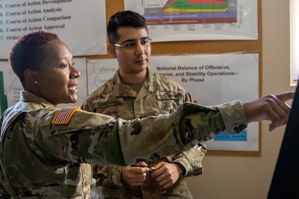 1st Lt. Tanisha Murray, 374th Financial Management Support Unit finance officer, and 1st Lt. Cesar Sandoval, 81st Readiness Division finance officer, discuss upcoming financial operations during exercise Diamond Saber at Joint Base McGuire-Dix, New Jersey, Aug. 13, 2022. Established in 2004, Diamond Saber is a U.S. Army Reserve-led exercise that trains and evaluates Soldiers and joint partners on warfighting functions such as funding the force, payment support, disbursing operations, accounting, fiscal stewardship, auditability and data analytics. (U.S. Army photo by Mark R. W. Orders-Woempner)