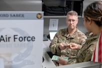 U.S. Air Force Reserve Tech. Sgt. Jon Ricks and Senior Airman Adrianne Alino, 446th Airlift Wing financial management specialists from Joint Base Lewis-McChord, Washington, close out daily transactions during exercise Diamond Saber at Joint Base McGuire-Dix, New Jersey, Aug. 14, 2022. Established in 2004, Diamond Saber is a U.S. Army Reserve-led exercise that trains and evaluates Soldiers and joint partners on warfighting functions such as funding the force, payment support, disbursing operations, accounting, fiscal stewardship, auditability and data analytics. (U.S. Army photo by Mark R. W. Orders-Woempner)