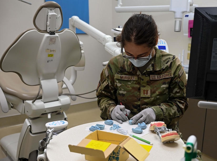 Dental resident forms a clay denture molding at JBLE.