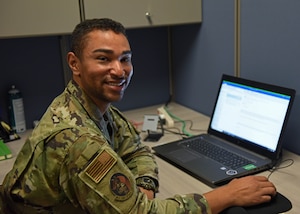 U.S. Air Force Tech. Sgt. Skott Cameron, 17th Comptroller Squadron noncommissioned officer in charge of financial operations, provides technical guidance to an Airman at Goodfellow Air Force Base, Texas, Aug. 16, 2022. Cameron has developed processes to save members of the 17th Training Wing time and money. (U.S. Air Force photo by Airman 1st Class Sarah Williams)