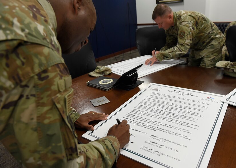 Col. Todd Randolph, 316th Wing and installation commander, signs a Suicide Prevention Month proclamation at Joint Base Andrews, Md., Aug. 31, 2022. The Department of Defense and JBA observe Suicide Prevention Month in September to bring forth awareness and to educate our military community about suicide prevention. (U.S. Air Force photo by Airman 1st Class Austin Pate)