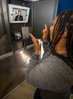 Sheila Marks, personnel support technician and Puget Sound Naval Shipyard & Intermediate Maintenance Facility employee of 34 years, demonstrates the use of one of the shipyard’s newly installed video phones. The video phones provide deaf and hard-of-hearing employees with convenient access to a live American Sign Language interpreter to assist with making phones calls to hearing-enabled individuals.
(U.S. Navy Photo by Wendy Hallmark)