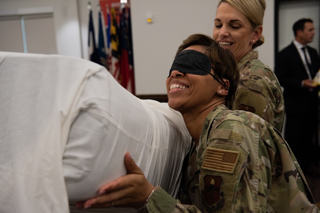 U.S. Air Force Chief Master Sgt. Lauren Brock, 17th Medical Group senior enlisted leader, teamed up with Maj. Gen. Michele Edmondson, Second Air Force commander, to compete in the 2nd annual challenge of the feathers during the Bazaar of Falcons event, Goodfellow Air Force Base, Texas, Aug. 26, 2022. The 17th TRW scored the highest among all the wings, dethroning the reigning champions, the Special Warfare Training Wing. (U.S. Air Force photo by Senior Airman Michael Bowman)