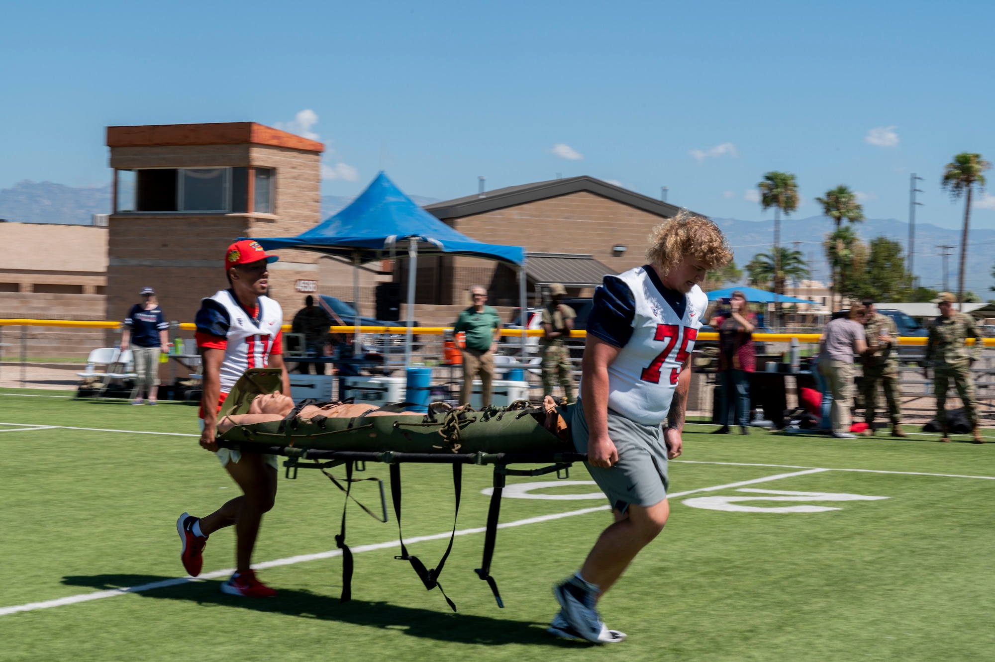 Photo of two guys carrying a stretcher.