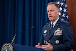 A man in a military uniform speaks during a news conference.