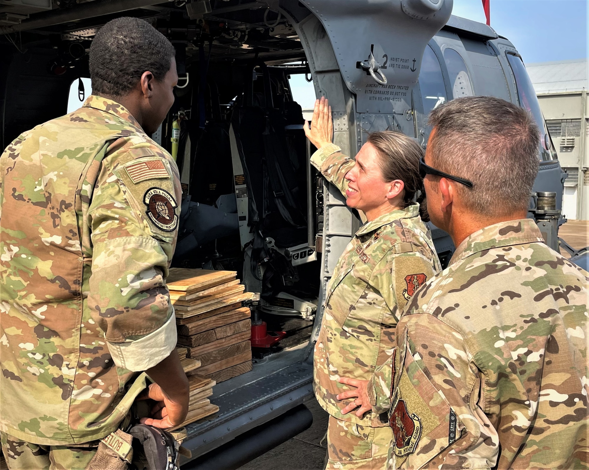 New York Air National Guard 106th Rescue Wing maintenance team member Master Sgt. Jordan Butler, HH-60 crew chief, speaks with Brig. Gen. Denise Donnell, the commander of the New York Air National Guard, and Col. Shawn Fitzgerald, the 106th Rescue Wing commander and Exercise TÁPIO American mission commander. The combined Brazilian-U.S. exercise occurred in and near Campo Grande, Brazil, Aug. 29, 2022.