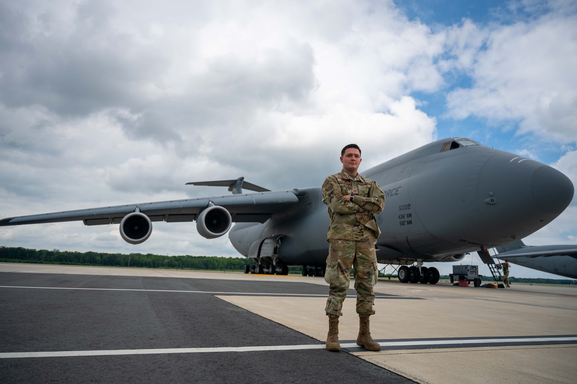 Staff Sgt. Noah Pascarella, 436th Aircraft Maintenance Squadron avionics technician, poses for a photo in front of a C-5M Super Galaxy, at Dover Air Force Base, Delaware, Aug. 1, 2022. Pascarella was deployed to Al Udeid Air Base, Qatar, during Operation Allies Refuge in 2021. (U.S. Air Force photo by Senior Airman Faith Barron)