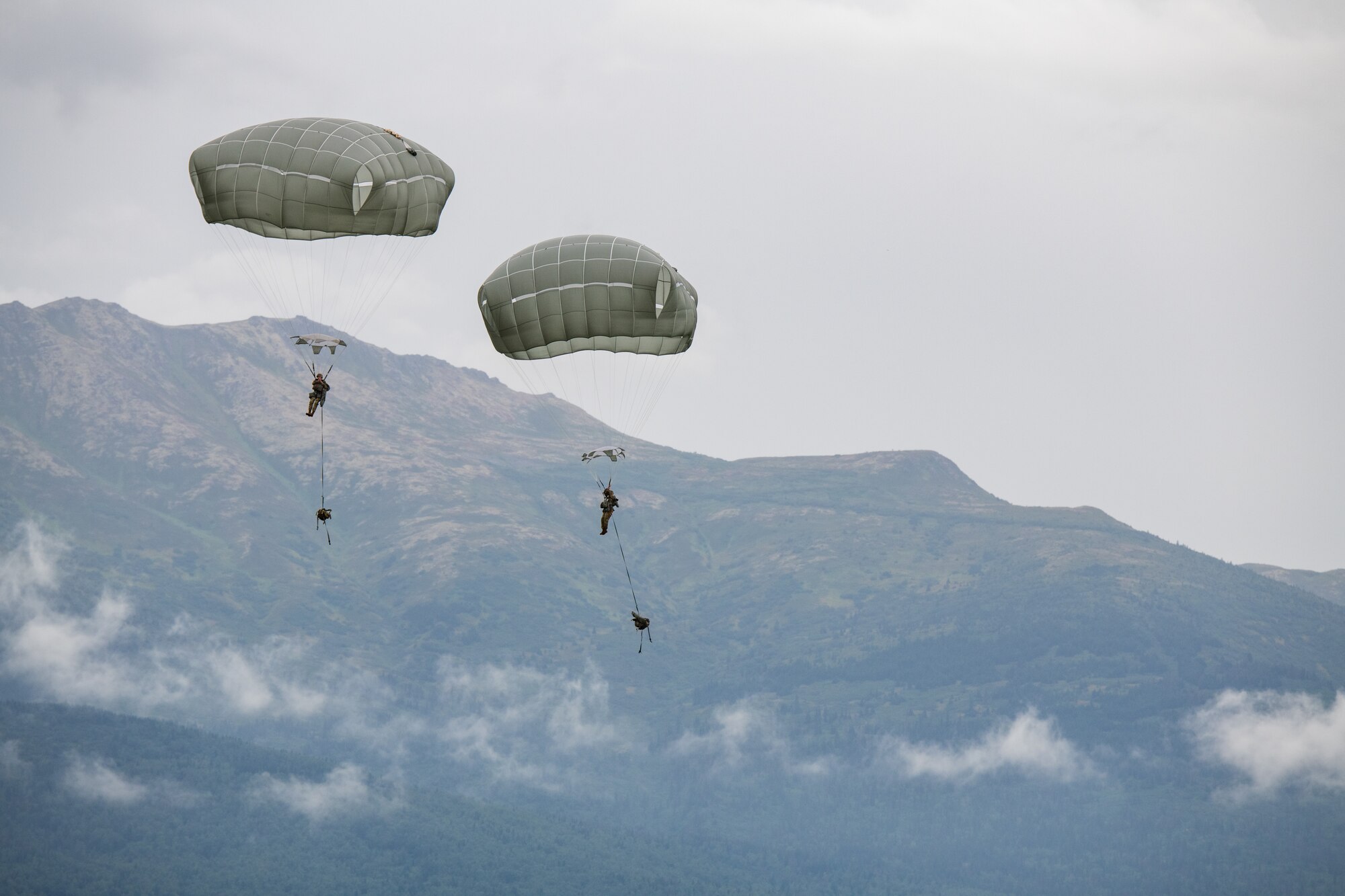 Soldiers use parachutes to descend after airborne operations.