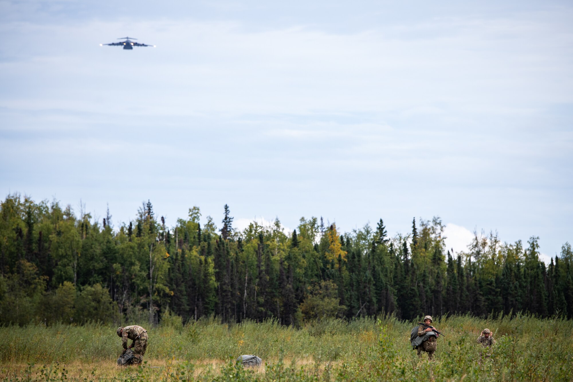 Soldiers collect their gear after airborne operations.