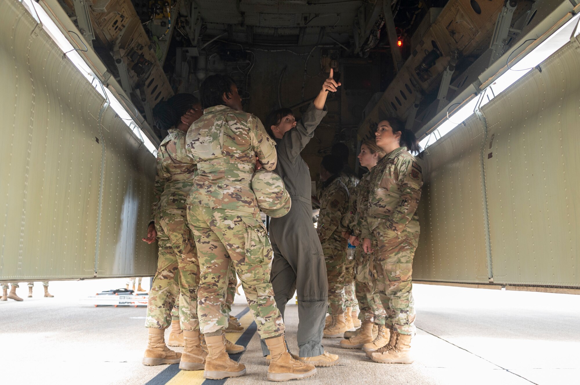 Airmen huddle in the bomb bay of a B-52
