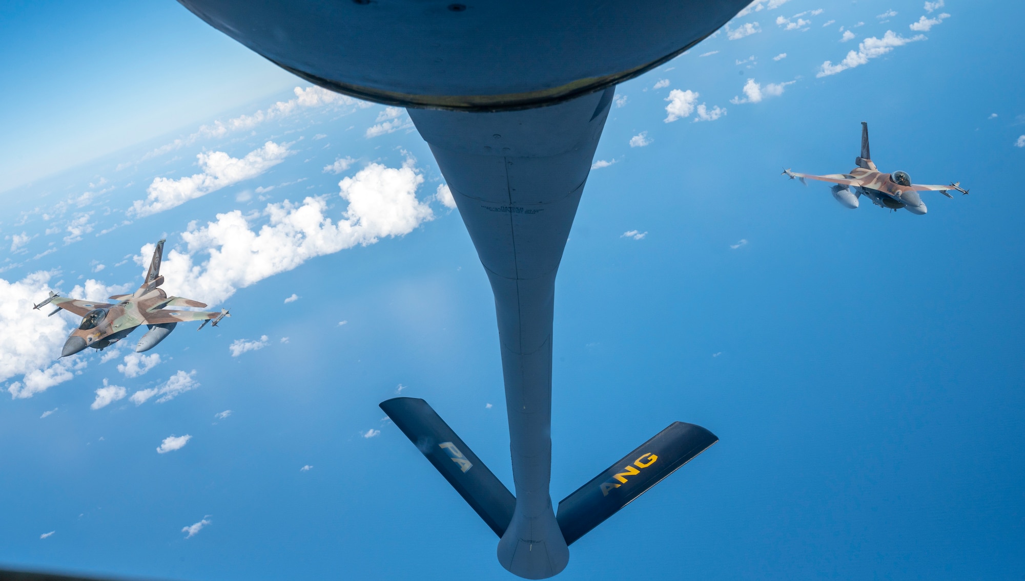 Two Israeli Air Force F-16 Fighting Falcons gather in formation behind a U.S. Air Force KC-135 Stratotanker assigned to the 340th Expeditionary Air Refueling Squadron, as part of a bilateral exercise in the U.S. Central Command area of responsibility, Nov. 30, 2022. The exercise demonstrated fighter aircraft integration and escort as well as refueling operations as part of the first of several exercises to maintain the ironclad commitment and bilateral aerial capability between the U.S. and Israeli air forces. (U.S. Air Force photo by Staff Sgt. Kirby Turbak)