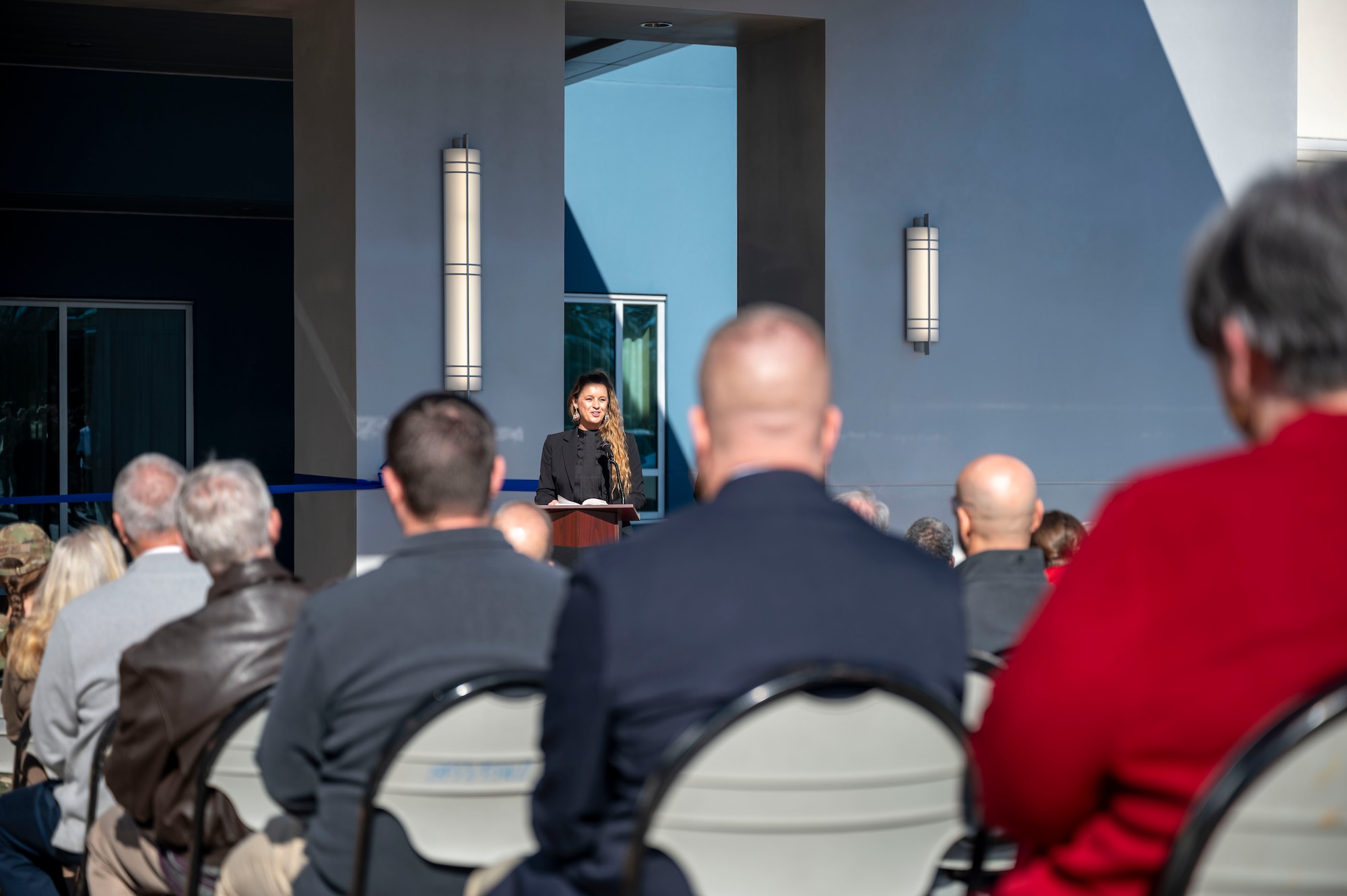 A woman gives a speech at a ceremony
