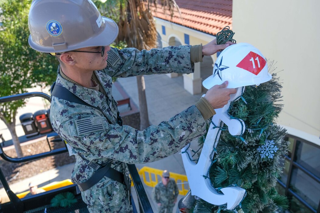 NMCB) 11 sets up a Christmas tree outside the Navy Exchange at Naval Station Rota, Spain.