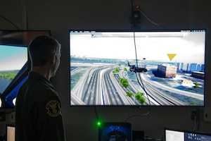 Maj. Mitchell Clapp, 316th Operations Support Squadron assistant director of operations, monitors a training mission on the virtual-reality helicopter flight simulator system at Joint Base Andrews, Md., Oct. 25, 2022.