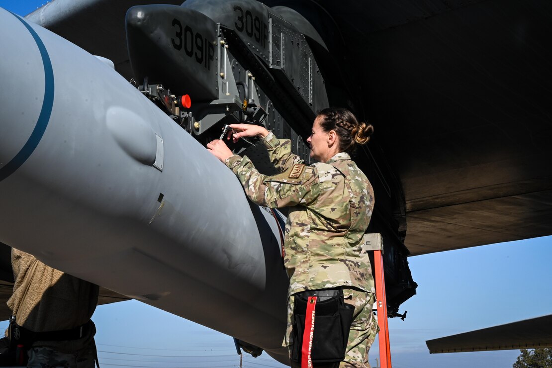U.S. Air Force Master Sgt. Marcella Philips, 2nd Maintenance Group weapons standardization loading standardization crew chief, tightens bolts to secure the weapon to a B-52H Stratofortress, at Barksdale Air Force Base, Louisiana, Nov. 2, 2022.