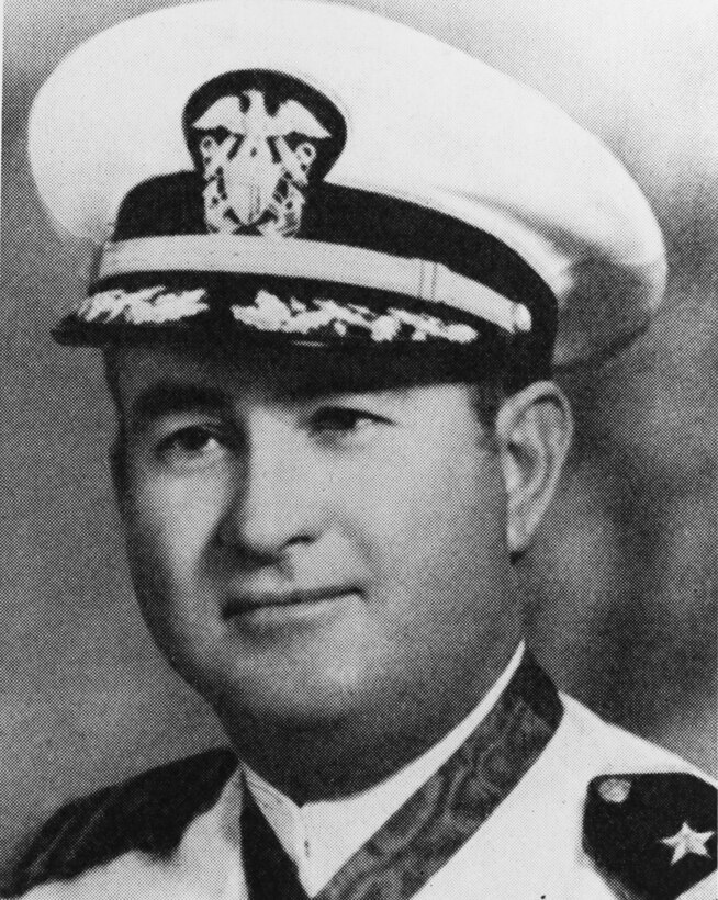 A man in a service cap poses for a photo.