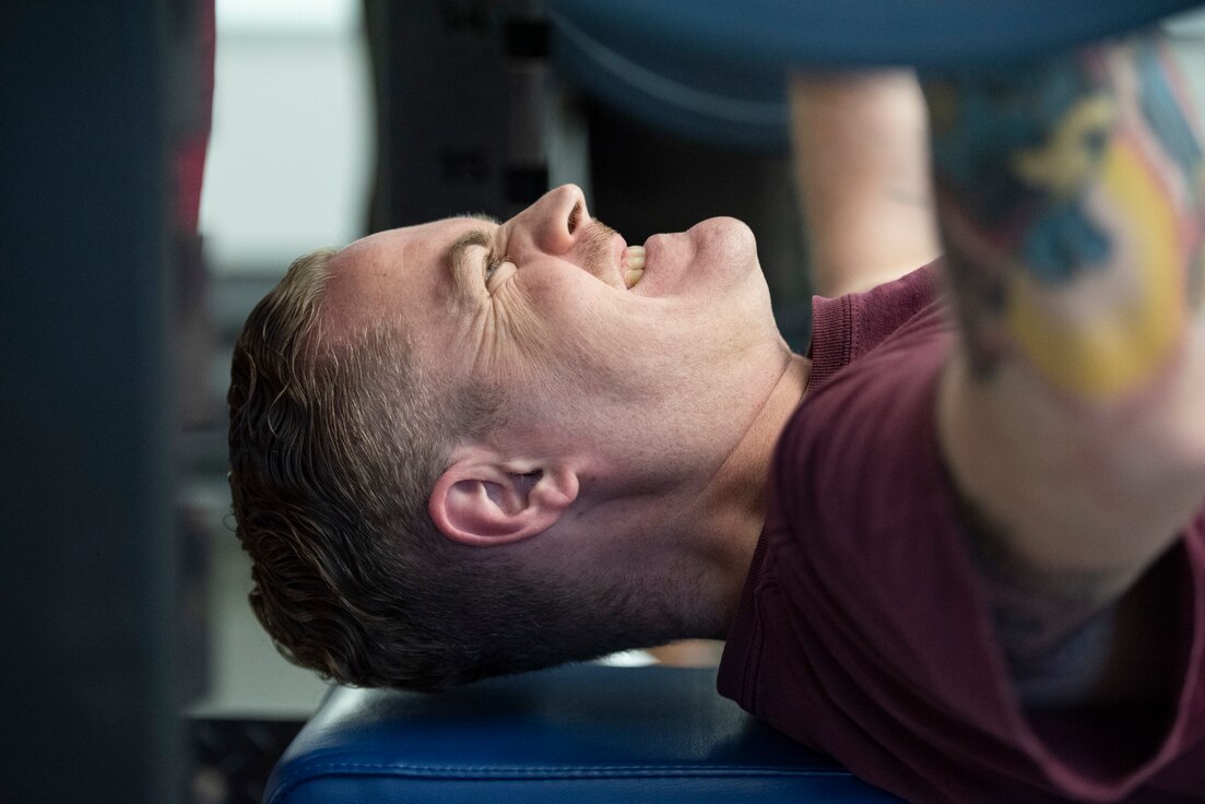 Close up view of an RSMs face while bench pressing.