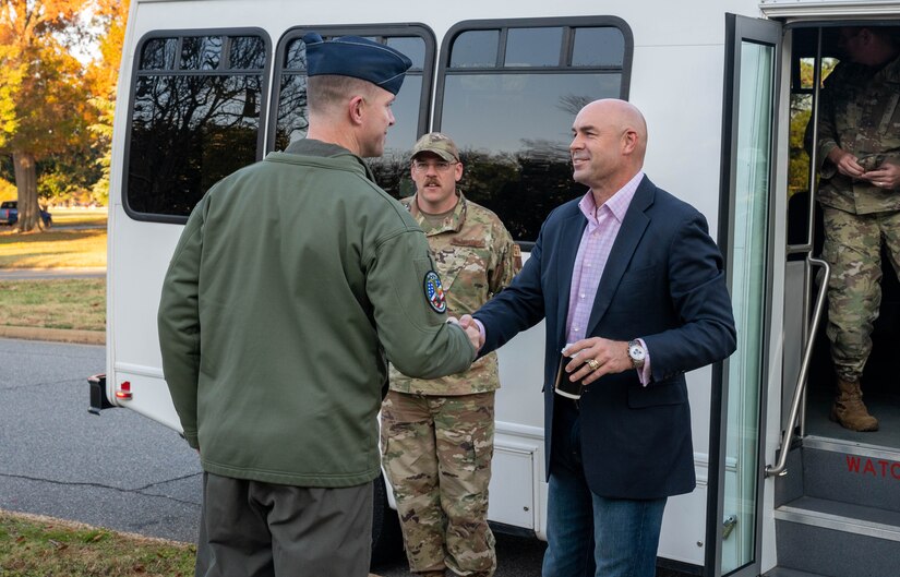 U.S. Air Force Col. William Creeden, 1st Fighter Wing commander, greets U.S. Rep. Jake Ellzey, of Texas, at Joint Base Langley-Eustis, Virginia, Nov. 29, 2022.