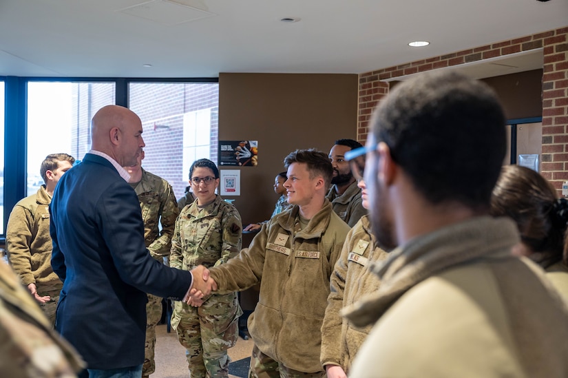 U.S. Rep. Jake Ellzey, of Texas, shakes hands with Airman 1st Class Keith Brothers, 30th Intelligence Squadron geospatial analyst, at Joint Base Langley-Eustis, Virginia, Nov. 29, 2022.