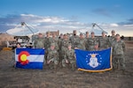 Members of the 138th Space Control Squadron, Colorado Air National Guard gather for a group photo at a forward operating base on Schriever Space Force Base, Colorado Springs, Colorado, Oct. 21, 2022. The Airmen of the 138th SPCS participated in the Neptune Falcon Exercise to test their capabilities in a contested multi-domain operation designed in preparation for real world space control missions. (U.S. Space Force Photo by Mr. Dennis Rogers)