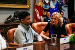 Shaun Gurtner, 14, step-son of U.S. Air Force Master Sgt.  Luke Hatton, Colorado Air National Guard is joined by Jill Biden, Ed.D., First Lady of the United States, National Guard family members, state adjutants general, and National Guard senior leaders for a roundtable discussion on support for National Guard children in the White House Roosevelt Room, Washington, D.C., Nov. 28, 2022. Attendees, including National Guard children, also joined the First Lady’s unveiling of the 2022 White House “We the People” holiday theme and decorations. (U.S. Army National Guard photo by Sgt. 1st Class Zach Sheely)