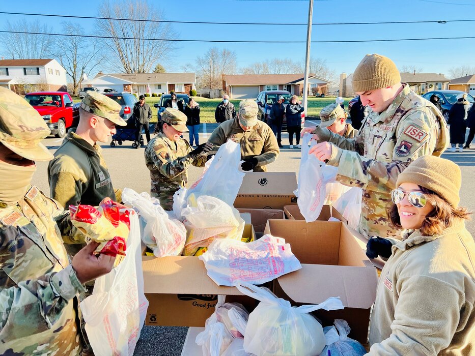 Airmen sort through food boxes.