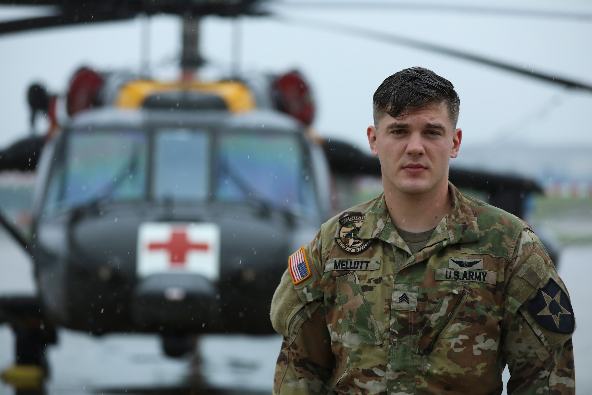 Sgt. Jake Mellott, a Critical Care Flight Paramedic (68WF2) from Charlie Company, 3-2 General Support Aviation Battalion, 2nd Combat Aviation Brigade, 2nd Infantry Division, poses for a portrait photo in front of an HH-60M MEDEVAC Helicopter, September 1, 2022, Camp Humphreys, Republic of Korea. Mellott is a part of the DMZ DUSTOFF working across the ROK conducting emergency medical evacuations and scenario training throughout the peninsula. (U.S. Army photo by Sgt. Oscar Toscano)