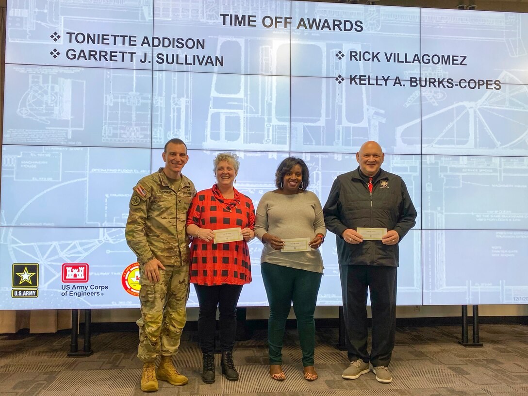 U.S. Army Corps of Engineers Galveston District Commander (left) Col. Rhett Blackmon awards several employees with some time off for their efforts and support in a series of open houses for the Port Arthur and Orange County projects.