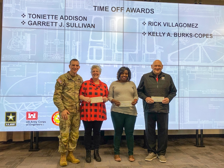 U.S. Army Corps of Engineers Galveston District Commander (left) Col. Rhett Blackmon awards several employees with some time off for their efforts and support in a series of open houses for the Port Arthur and Orange County projects.