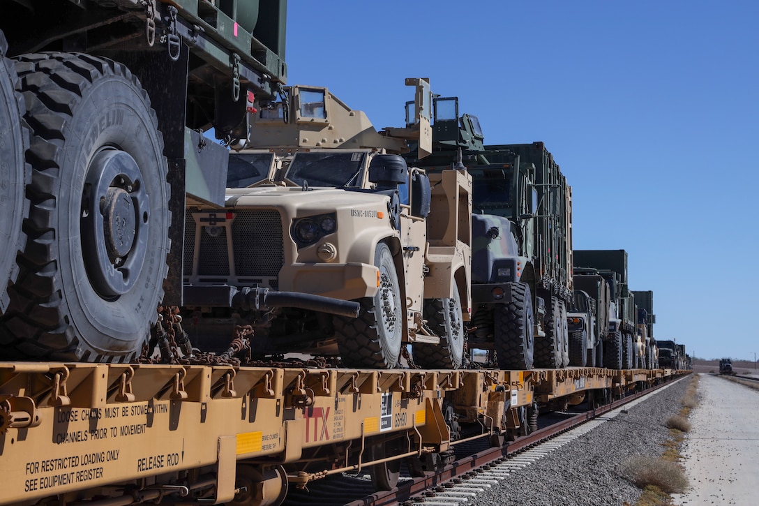 U.S. Marine Corps vehicles are chained down onto a train car during railroad operations amid Weapons and Tactics Instructor (WTI) Course 1-23 near Glamis, California, Nov. 4, 2022.