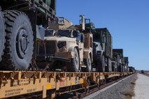 U.S. Marine Corps vehicles are chained down onto a train car during railroad operations amid Weapons and Tactics Instructor (WTI) Course 1-23 near Glamis, California, Nov. 4, 2022. The Marine Corps Air Station Yuma, Arizona, Distribution Management Office assisted 1st Landing Support Battalion, 1st Marine Logistics Group and 2nd Transportation Battalion, 2nd Marine Logistics Group, as they loaded equipment being extracted from WTI onto train cars, Oct. 31 to Nov. 7, 2022. (U.S. Marine Corps photo by Lance Cpl. Jon C. Stone)