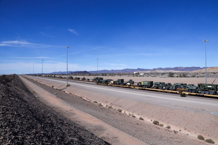 U.S. Marine Corps vehicles and cargo loaded on a train during railroad operations amid Weapons and Tactics Instructor (WTI) Course 1-23 near Glamis, California, Nov. 4, 2022. The Marine Corps Air Station Yuma, Arizona, Distribution Management Office assisted 1st Landing Support Battalion, 1st Marine Logistics Group and 2nd Transportation Battalion, 2nd MLG, as they loaded equipment being extracted from WTI onto train cars, Oct. 31 to Nov. 7, 2022. (U.S. Marine Corps photo by Lance Cpl. Jon C. Stone)