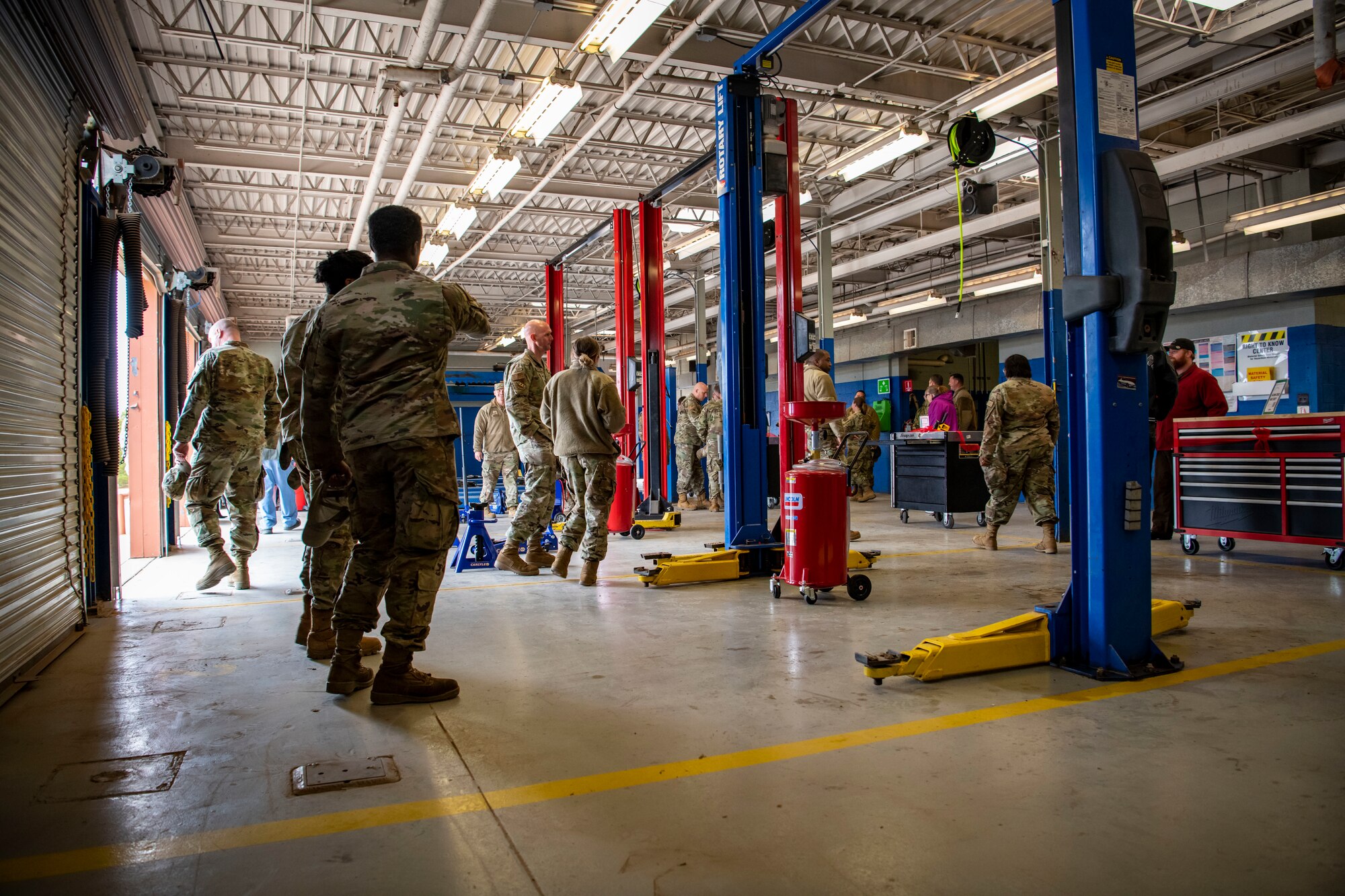 Airman from the 7th Bomb Wing gather for a tour of the new Dyess Auto Hobby Shop during the grand opening ceremony at Dyess Air Force Base, Texas, Dec. 1, 2022. The outdoor recreation facility recently underwent remodeling and now can provide a greater variety of services for Airmen and their families. (U.S. Air Force photo by Senior Airman Leon Redfern)