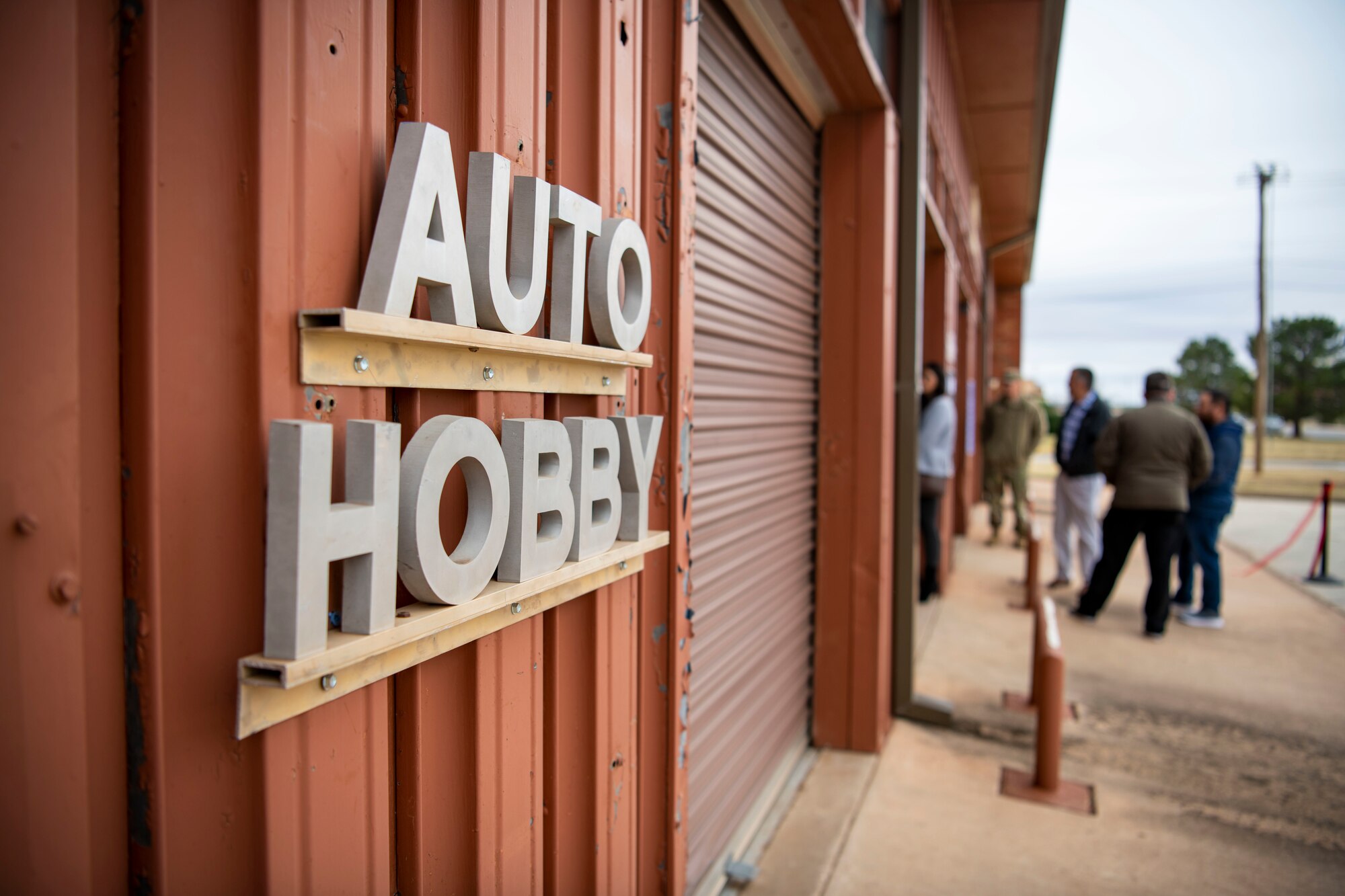 A sign reading “Auto Hobby” is displayed during the grand opening ceremony for the Dyess Auto Hobby Shop at Dyess Air Force Base, Texas, Dec. 1, 2022. The Dyess Auto Hobby Shop will provide affordable vehicle maintenance services to base personnel while supporting morale and welfare needs for Dyess Airmen. (U.S. Air Force photo by Senior Airman Leon Redfern)