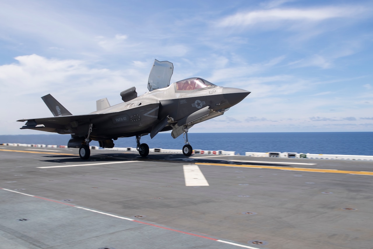 An aircraft lifts off the deck of a ship.