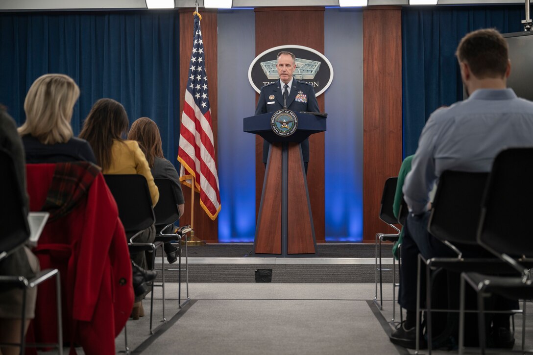 A man speaks from a podium.