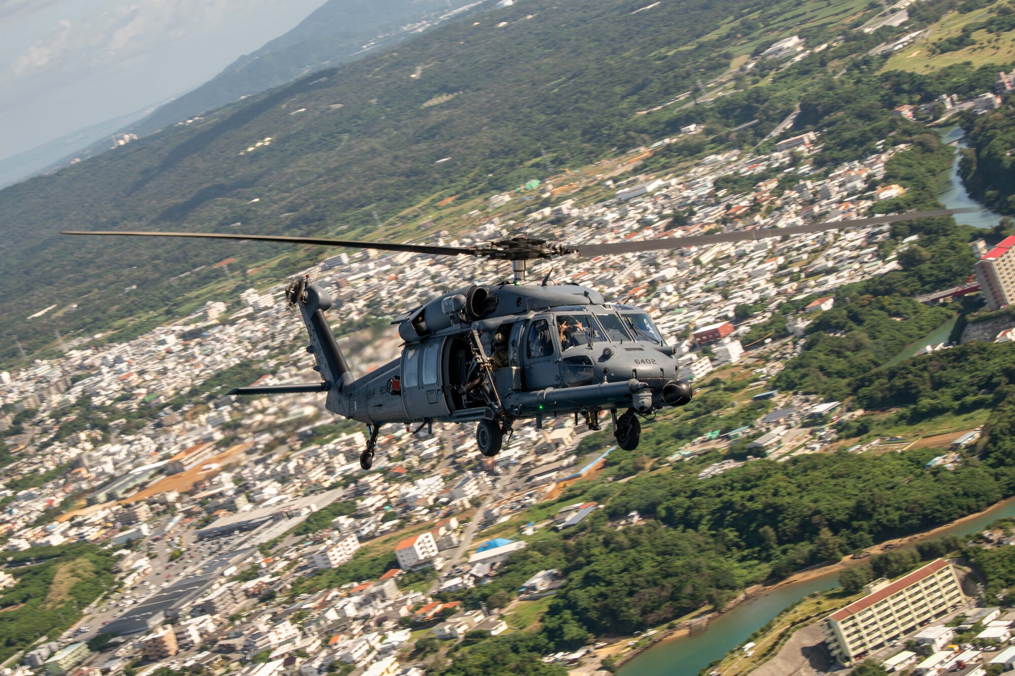 A helicopter flies over a city
