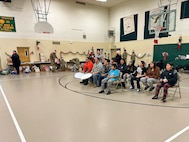 Community members share a traditional Inupiaq song with volunteers supporting Operation Santa Claus at the Trapper School in Nuiqsut, Alaska, Nov. 29, 2022. Operation Santa Claus is the Alaska National Guard’s yearly community relations and support program that provides gifts to children in remote communities across the state. In partnership with the Salvation Army, Santa, Mrs. Claus and more than three dozen elves delivered 1,420 pounds of gifts, backpacks, hygiene supplies, and books to 191 children in Nuiqsut.