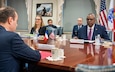 A group of people sit around a large table.