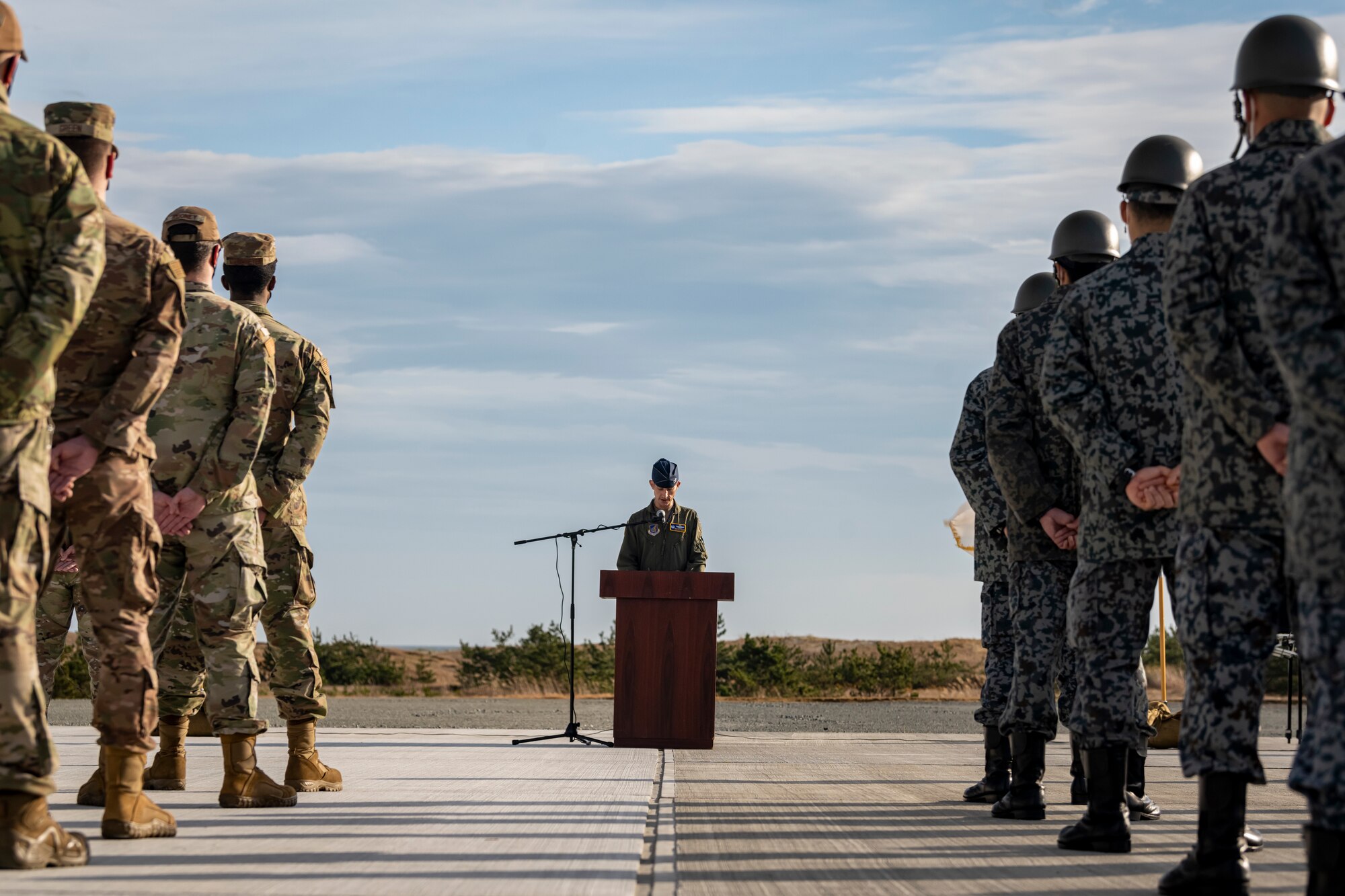 U.S. Air Force and Japan Air Self-Defense Force members, assigned to the 35th Civil Engineer Squadron and the Northern Air Civil Engineering Group, attend a ceremony to commemorate the completion of a bilateral Rapid Airfield Damage Recovery (RADR) pad at Draughon Range near Misawa Air Base, Japan, Nov. 29, 2022.