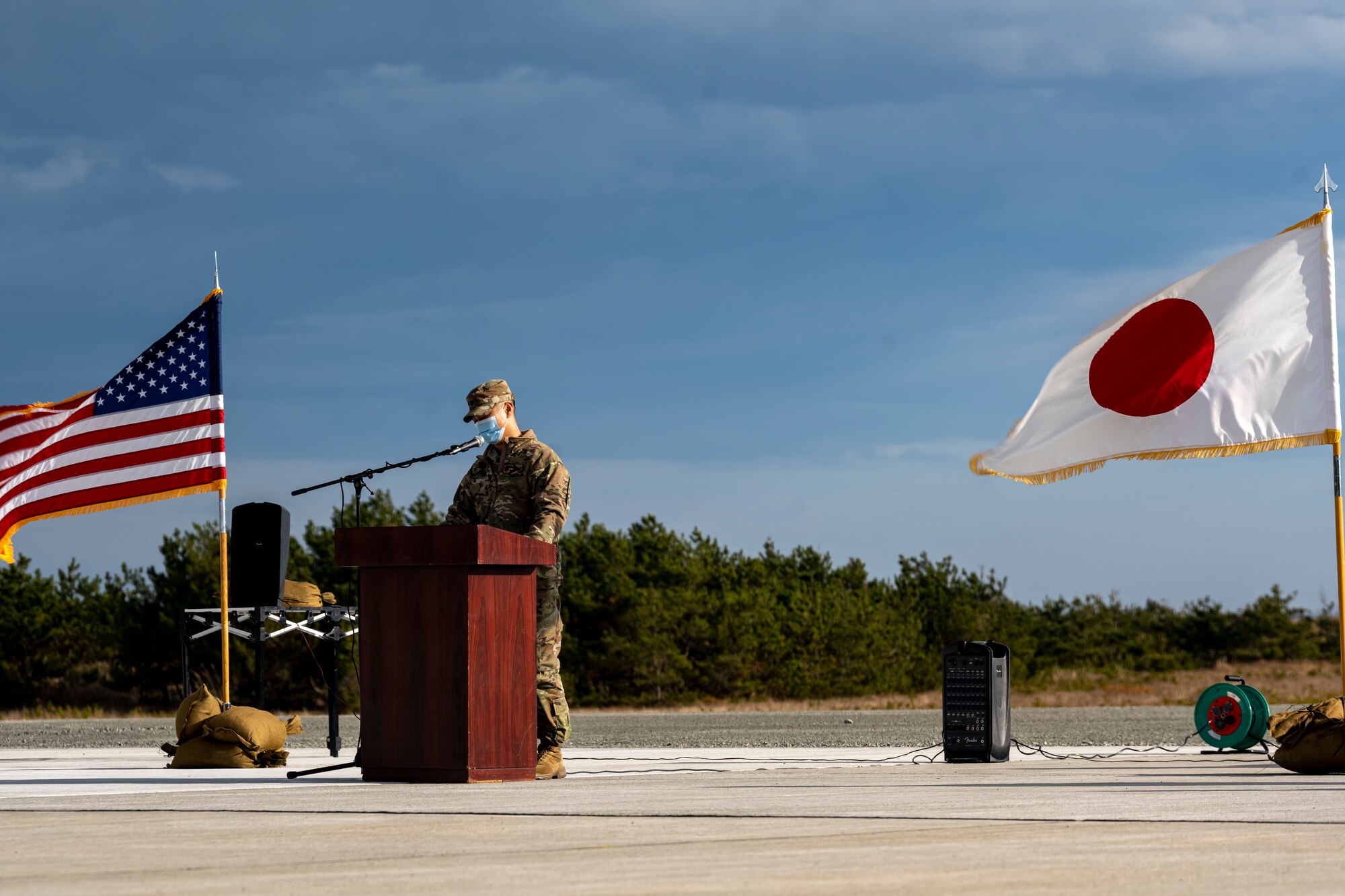 U.S. Air Force and Japan Air Self-Defense Force members, assigned to the 35th Civil Engineer Squadron and the Northern Air Civil Engineering Group, attend a ceremony to commemorate the completion of a bilateral Rapid Airfield Damage Recovery (RADR) pad at Draughon Range near Misawa Air Base, Japan, Nov. 29, 2022.