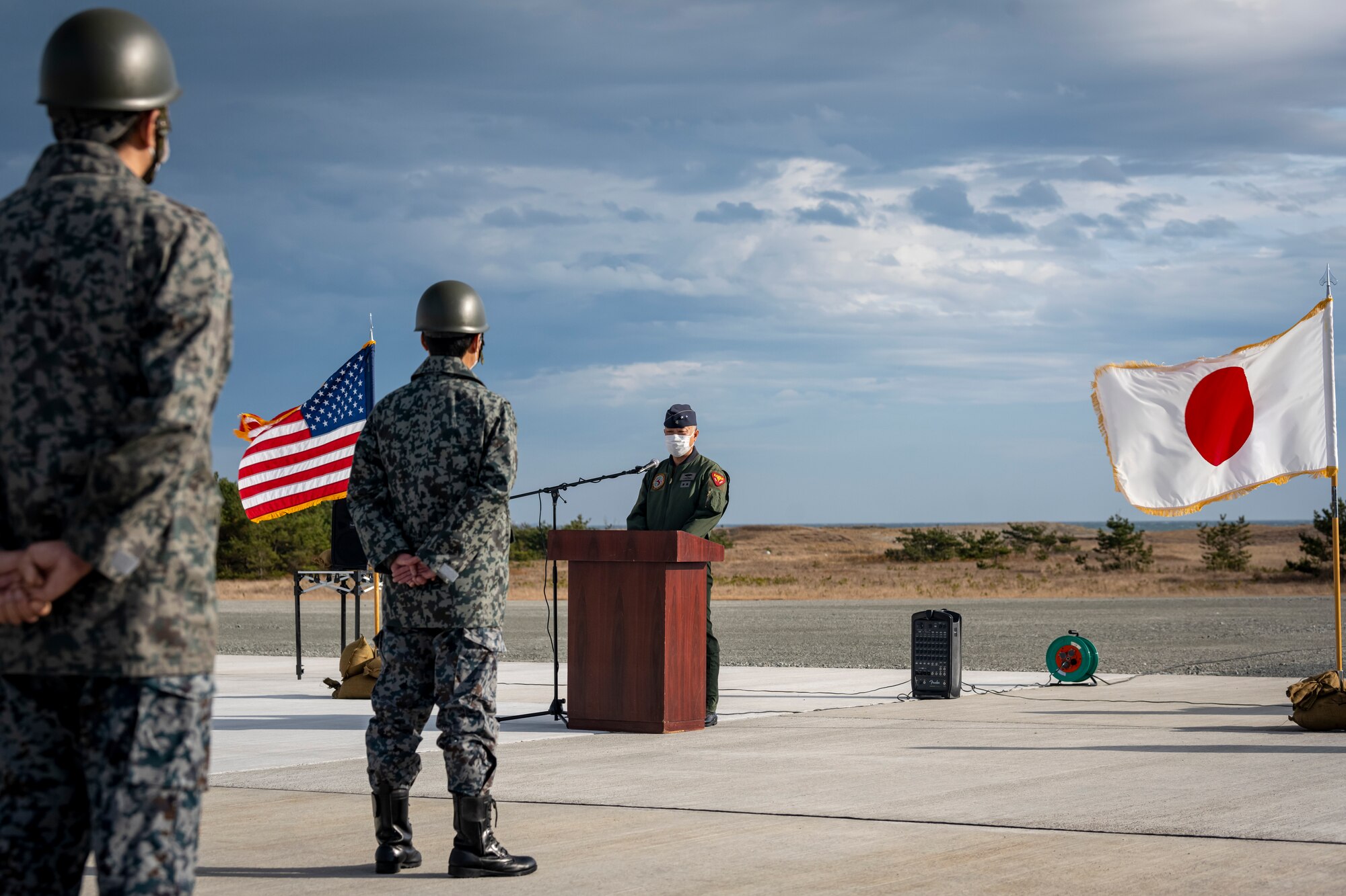 U.S. Air Force and Japan Air Self-Defense Force members, assigned to the 35th Civil Engineer Squadron and the Northern Air Civil Engineering Group, attend a ceremony to commemorate the completion of a bilateral Rapid Airfield Damage Recovery (RADR) pad at Draughon Range near Misawa Air Base, Japan, Nov. 29, 2022.