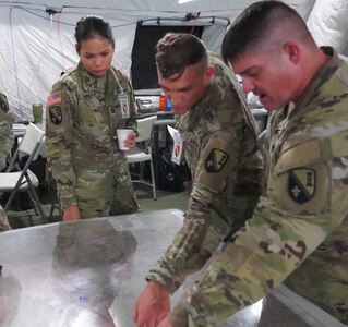 Louisiana National Guardsmen assigned to the 225th Engineer Brigade review a map during Warfighter 23-2 at Fort Stewart, Georgia, Nov. 1, 2022.