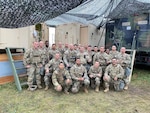 40th Infantry Division Soldiers take a group photo in their division tactical command post area during Warfighter Exercise 23-2 at Camp Atterbury, Indiana, Nov. 9, 2022. A warfighter exercise is a 10-day training event used as a capstone for division and corps echelons and is typically conducted biannually.